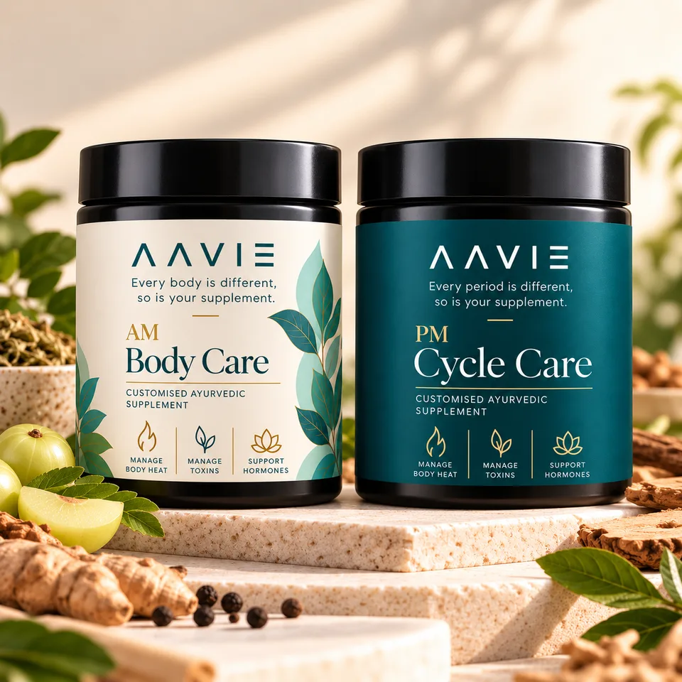 AAVIE AM Body Care and PM Cycle Care herbal supplement jars surrounded by Ayurvedic herbs